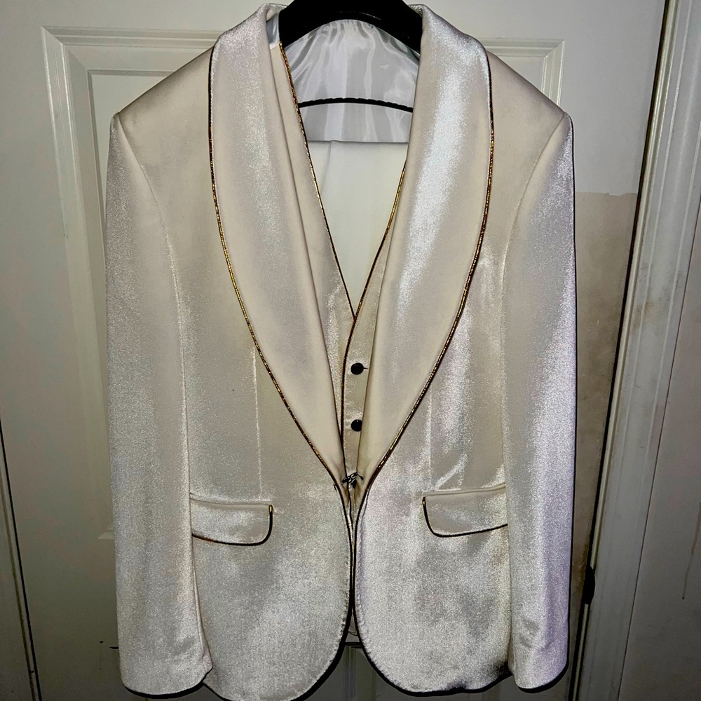 Men's formal white suit with gold trim.